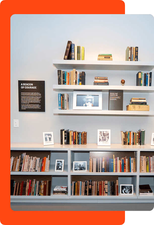 Images of books on a shelf in the exhibit