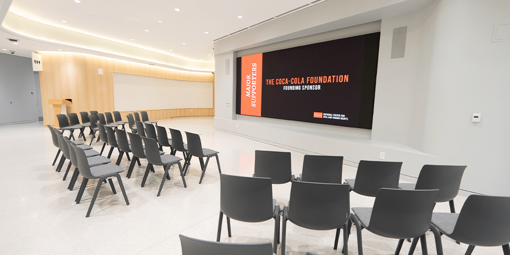 Classroom event space with chairs and large screen at NCCHR